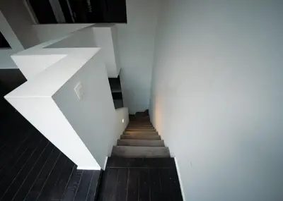 a stairway with white walls and a white stair case at Prestige Stay - Uptown in Brussels