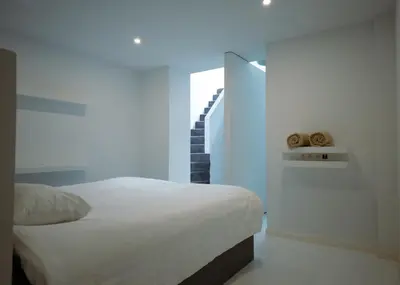 a bedroom with a white bed and a staircase at Prestige Stay - Uptown in Brussels