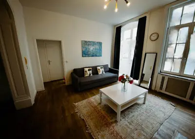 a living room with a couch and a table at Prestige Stay - Uptown in Brussels