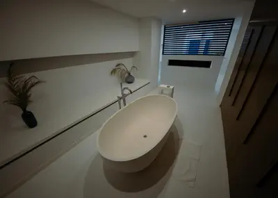 a white toilet in a white bathroom with a window at Prestige Stay - Uptown in Brussels
