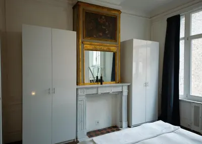 a room with a fireplace and a mirror on the wall at Prestige Stay - Uptown in Brussels