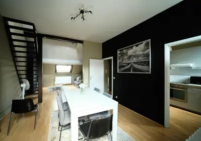 a kitchen and dining room with a white table and chairs at Prestige Stay - Uptown in Brussels