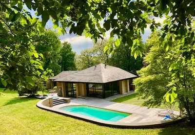 a swimming pool with a gazebo in a yard at Villa des Templiers - 20 min Brussels Airport in Wavre