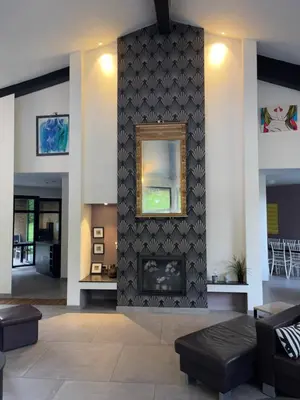 a living room with a fireplace and a mirror at Villa des Templiers - 20 min Brussels Airport in Wavre