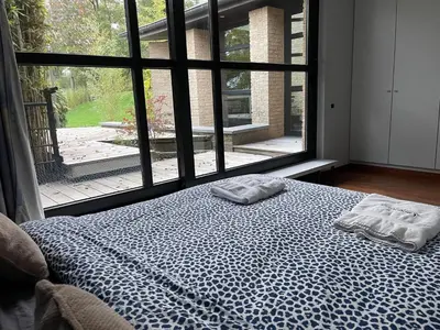 a bedroom with a bed with two towels on it at Villa des Templiers - 20 min Brussels Airport in Wavre