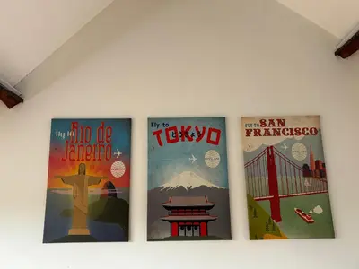three posters on the wall of a room at Vakantiewoning Huis 14 in Mechelen