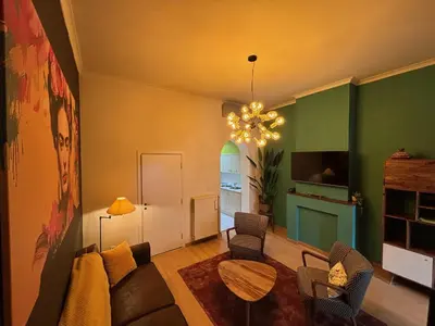 a living room with a couch and a table at Vakantiewoning Huis 14 in Mechelen