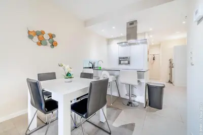 a kitchen and dining room with a white table and chairs at Center of Antwerp - Fully Renovated - Private Indoor Parking in Antwerp