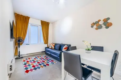 a living room with a table and a couch at Center of Antwerp - Fully Renovated - Private Indoor Parking in Antwerp