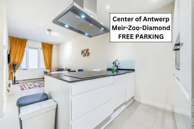 a kitchen with a white counter and a sink at Center of Antwerp - Fully Renovated - Private Indoor Parking in Antwerp
