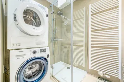 a bathroom with a washing machine and a shower at Center of Antwerp - Fully Renovated - Private Indoor Parking in Antwerp