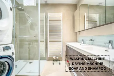 a bathroom with a shower and a sink and a washing machine at Center of Antwerp - Fully Renovated - Private Indoor Parking in Antwerp