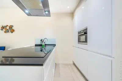 a kitchen with a sink and a stove at Center of Antwerp - Fully Renovated - Private Indoor Parking in Antwerp
