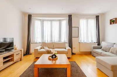 a living room with a couch and a coffee table at Le Joyau à Etterbeek in Brussels