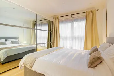 a bedroom with a large bed and a window at Le Joyau à Etterbeek in Brussels
