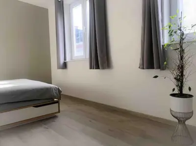 a bedroom with a bed and a potted plant at Chère Anna City Center New Top location in Ghent