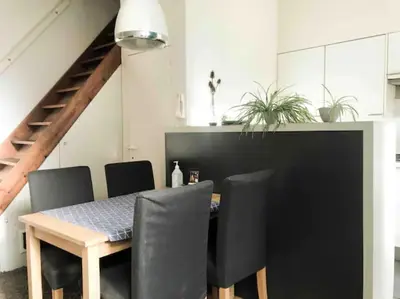 a dining room with a table and black chairs at Chère Anna City Center New Top location in Ghent