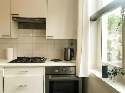 a kitchen with a stove top oven next to a window at Chère Anna City Center New Top location in Ghent