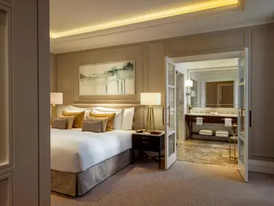 a bedroom with a bed and a bathroom with a piano at Corinthia Grand Hotel Astoria Brussels in Brussels