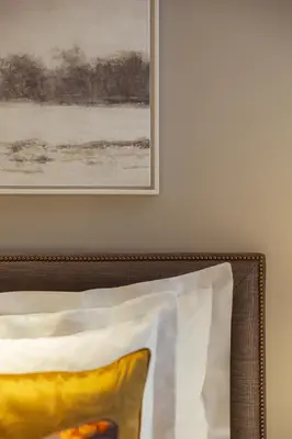 a picture hanging on a wall next to a pillow at Corinthia Grand Hotel Astoria Brussels in Brussels