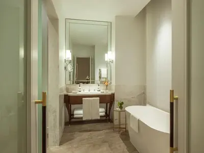 a bathroom with a tub and a sink at Corinthia Grand Hotel Astoria Brussels in Brussels