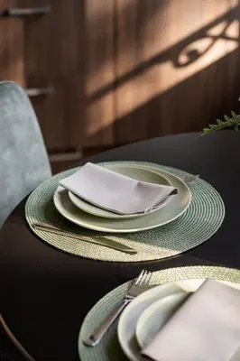 a table with plates and a napkin on it at Moneta in Antwerp
