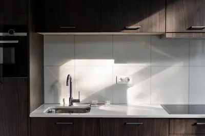 a kitchen with a sink and wooden cabinets at Moneta in Antwerp