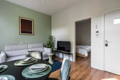 a living room with a table and a couch at Moneta in Antwerp