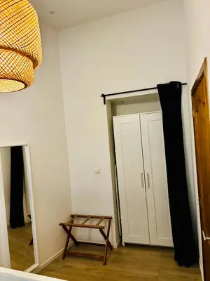 a room with a closet with a door and a stool at Sublime appartement au centre de Bruxelles in Brussels