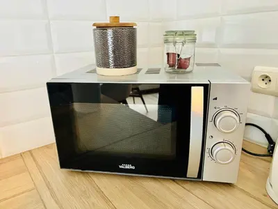 a microwave oven on a counter with a container on top at Sublime appartement au centre de Bruxelles in Brussels