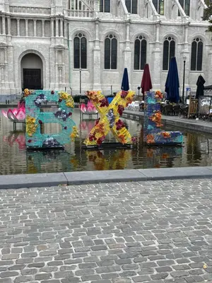 a sculpture in the water in front of a building at Sublime appartement au centre de Bruxelles in Brussels