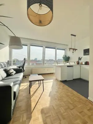a living room with a couch and a table at Petit cocon à Ixelles - Quartier Européen in Brussels