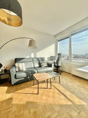 a living room with a couch and a table at Petit cocon à Ixelles - Quartier Européen in Brussels