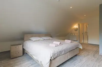 a bedroom with a bed with two towels on it at Villa Remis in Sint-Denijs-Westrem