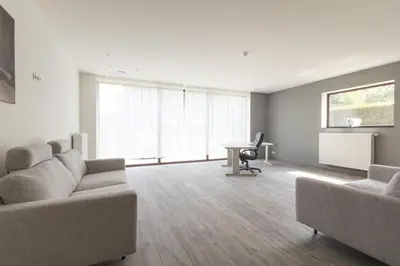 a living room with two couches and a desk at Villa Remis in Sint-Denijs-Westrem