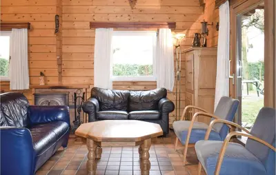 a living room with leather furniture and a fireplace at Ranchero in Wachtebeke