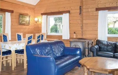 a living room with a leather couch and a table at Ranchero in Wachtebeke