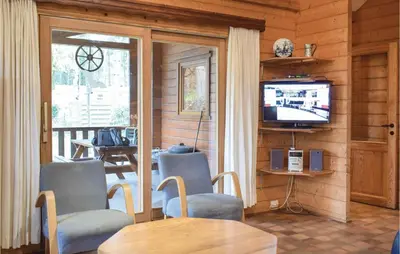 a living room with a television and a table and chairs at Ranchero in Wachtebeke