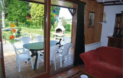 a room with a table and chairs on a patio at Groene Vallei in Wachtebeke