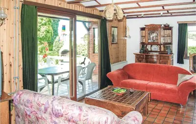 a living room with a red couch and a table at Groene Vallei in Wachtebeke