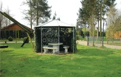 a gazebo with a bench in a park at Groene Vallei in Wachtebeke