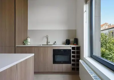 a kitchen with a sink and a window at Elegant Escape in hartje Zuid in Antwerp