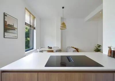 a kitchen with a white counter top and a table at Elegant Escape in hartje Zuid in Antwerp