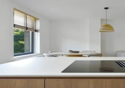 a kitchen with a white counter top and a table at Elegant Escape in hartje Zuid in Antwerp