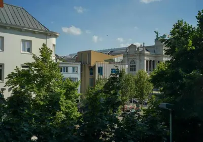 a group of trees in a city with buildings at Elegant Escape in hartje Zuid in Antwerp