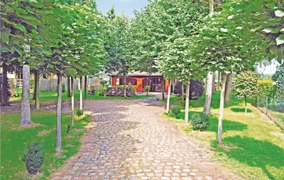 a cobblestone path through a garden with trees at Flamenco in Wachtebeke