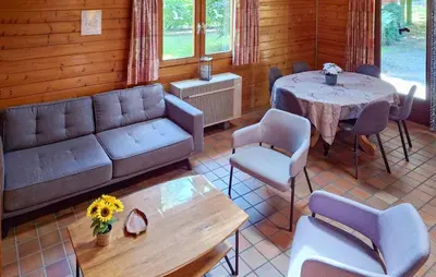 a living room with a couch and a table and chairs at Flamenco in Wachtebeke