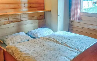 a bed in a room with a wooden wall at Flamenco in Wachtebeke