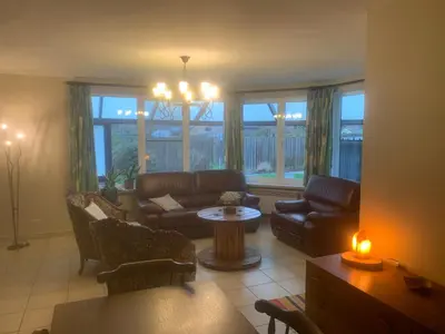 a living room with a couch and a table at Twisted Willow in Dendermonde