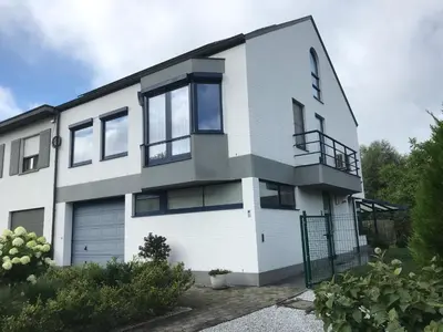 a white house with a lot of windows at Twisted Willow in Dendermonde